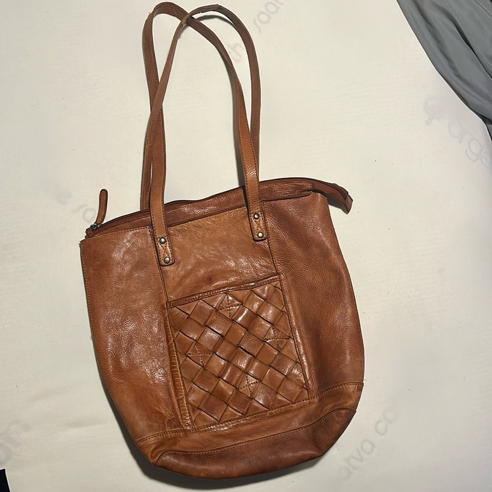 Leather bag with zipper closure at top & snap front detailed pocket in front